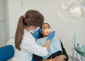 Dentist conducting a dental examination on a patient in a modern clinic setting.